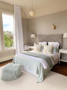 A bed or beds in a room at The Vicarage Boutique Bed and Breakfast Oamaru