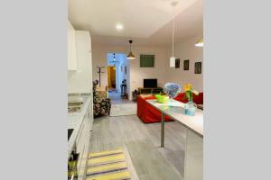 a kitchen and living room with a red couch at Braga Forum House in Braga