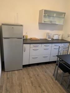 a kitchen with a white refrigerator and a table at Feuerbachstr.9 Ferienwohnung in Bottrop