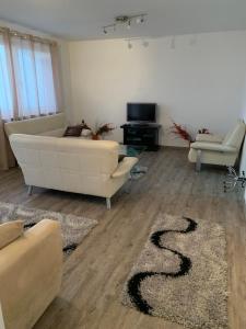 a living room with a white couch and a rug at Feuerbachstr.9 Ferienwohnung in Bottrop