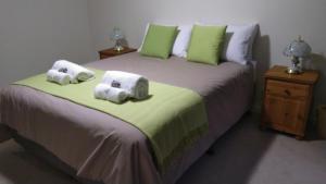 a bedroom with a large bed with towels on it at Broxholme B&B in Denmark