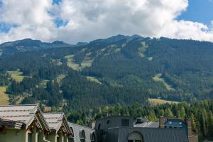 a view of a mountain with trees and buildings at Adara Hotel in Whistler