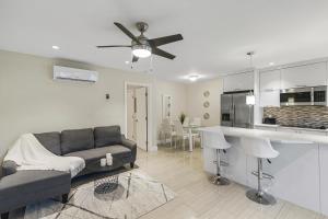 a living room with a couch and a kitchen at Alani Bay Condos in Fort Lauderdale