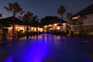a swimming pool lit up at night with blue lights at LGood Lembongan Island Villas in Nusa Lembongan