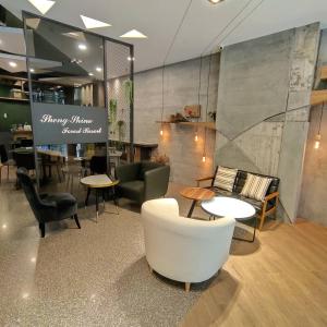 a lobby with chairs and tables in a building at Sheng Shine Forest Resort in Lugu