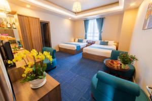 Postel nebo postele na pokoji v ubytování Rum Vang Hotel Da Lat