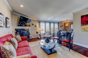 a living room with a red couch and a table at House-Canyon Dr in Oceanview