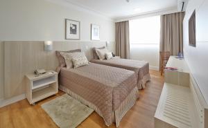 Voodi või voodid majutusasutuse Porto Feliz Executive Hotel toas