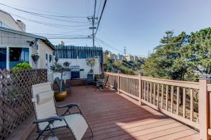 a wooden deck with chairs and a table on it at House-Canyon Dr in Oceanview