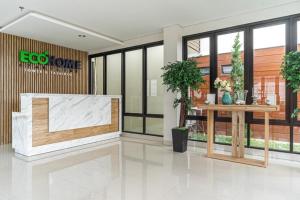 a lobby of a building with a large window at RedDoorz Plus @ EcoHome Citra Raya Tangerang in Tangerang