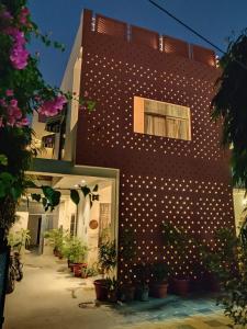 a brick building with white polka dots on it at Kalpana Yoga Homestay in Jaipur