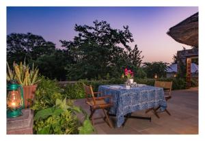 a table with a blue table cloth on a patio at Khem Villas in Sawāi Mādhopur