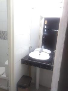 a bathroom with a sink and a toilet at skyz hostel in Padang