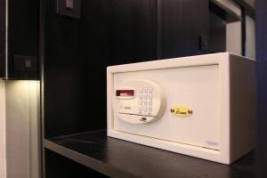 a white microwave oven sitting on top of a counter at Pratunam Atrium Hotel in Bangkok