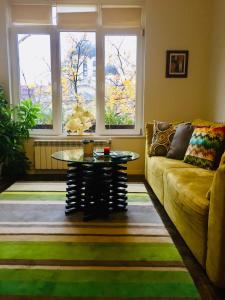 a living room with a couch and a table at Sweet home in the heart of Sofia in Sofia