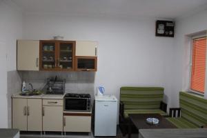 a small kitchen with a stove and a refrigerator at Apartment - NANE - Krushevo in Kruševo