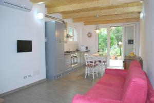 een woonkamer met een roze bank en een keuken bij La Tinaia in Florence