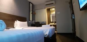 Voodi või voodid majutusasutuse MIICO Hotel @ Mount Austin toas
