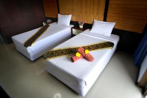 Postel nebo postele na pokoji v ubytování Suppamitr Villa Hotel