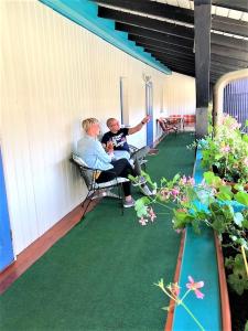 two older men sitting on a porch on a patio at Alter Ackerbuergerhof in Bad Frankenhausen