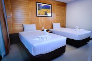 Postel nebo postele na pokoji v ubytování Suppamitr Villa Hotel