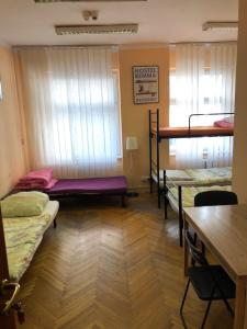 a room with a bed, desk, chair and a window at Hostel Bemma - Ozonowane pokoje in Wrocław