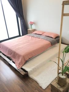 a large bed in a room with a large window at 1993’s house in Ho Chi Minh City