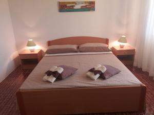 - une chambre avec un lit avec deux oreillers et deux lampes dans l'établissement Apartments Franka, à Sumartin