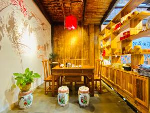 a dining room with a wooden table and chairs at Xishan Wutong Qinyuan (Free Pick up Service) in Huangshan