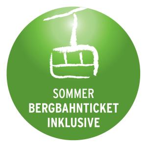 a green button with a sign that says summer bergarin architect inclusive at Hotel Müggelturm in Oberstdorf