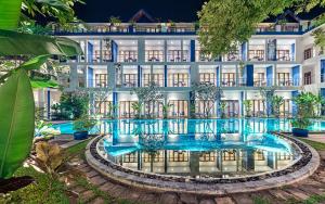 an exterior view of a hotel with a swimming pool at Sakmut Boutique Hotel in Siem Reap