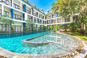 a swimming pool in front of a building at Sakmut Boutique Hotel in Siem Reap
