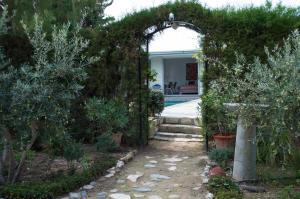 an archway leading into a garden with a pool at Idyllic studio with private pool in Nicosia