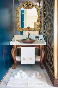 a bathroom with a mirror, sink, and bathtub at Daru Sultan Hotels Galata in Istanbul