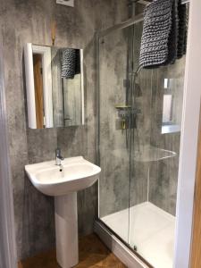 a bathroom with a sink and a shower at The Milking Parlour, Wolds Way Holiday Cottages, 1 bed cottage in Cottingham