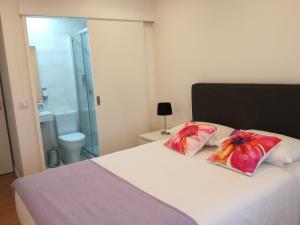 a bedroom with a bed with two pillows on it at Casa da Levada in Ribeira Grande