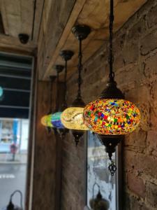 a group of colorful lights hanging from a wall at Cappadocia Guest House in Brighton & Hove