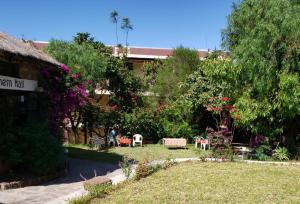 a garden with tables and chairs and a building at Jerusalem Hotel Lalibela in Lalibela