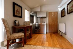 a kitchen with a table and a desk in a room at The Rectory Rooms, Studio 1 in Skipton