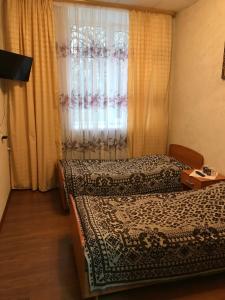 Кровать или кровати в номере СПА Волга
