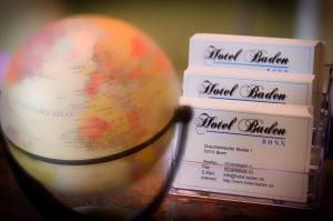 a stack of books and a globe on a table at Hotel Baden in Bonn