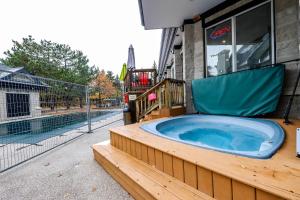a jacuzzi tub sitting outside of a building at Condo 305 at North Creek Resort in Blue Mountains +23 photos