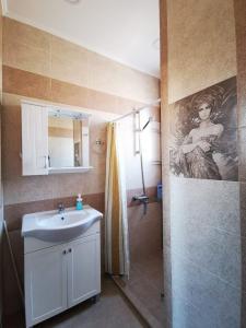 a bathroom with a sink and a shower at Serdika station, bright and cozy apartment in Sofia