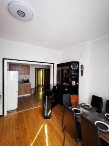 a living room with a dining room table and a kitchen at Serdika station, bright and cozy apartment in Sofia