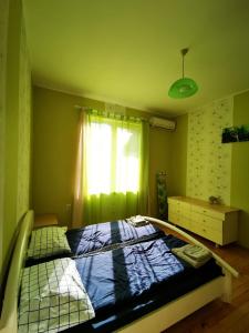 a bed in a room with a window at Serdika station, bright and cozy apartment in Sofia