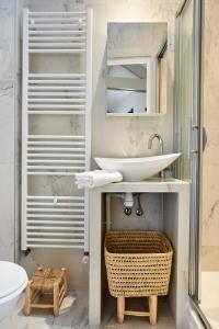 a bathroom with a sink and a mirror at My Maison In Paris - Sentier in Paris