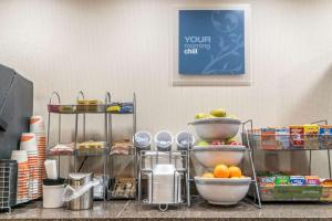 a kitchen with a bunch of food on a counter at Comfort Suites in Owensboro +27 photos