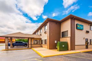 a hotel with a parking lot in front of a building at Quality Inn Tomah in Tomah