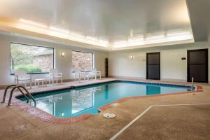 uma grande piscina com cadeiras num quarto em Comfort Suites Dayton-Wright Patterson em Dayton