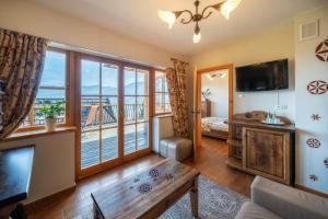 a living room with a view of the ocean at Butorowy Dwór in Kościelisko